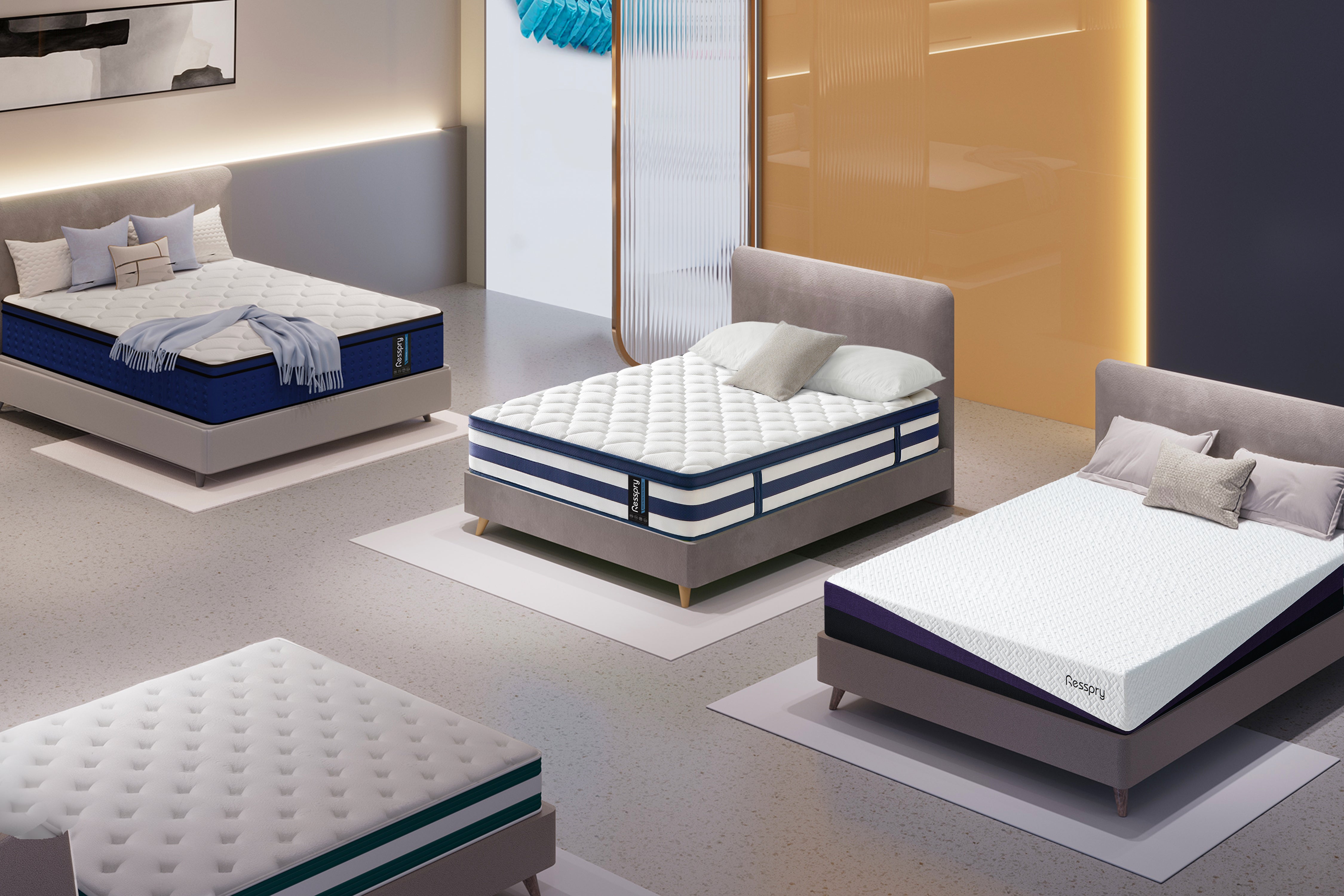 Three mattresses on display in a showroom with neutral lighting.
