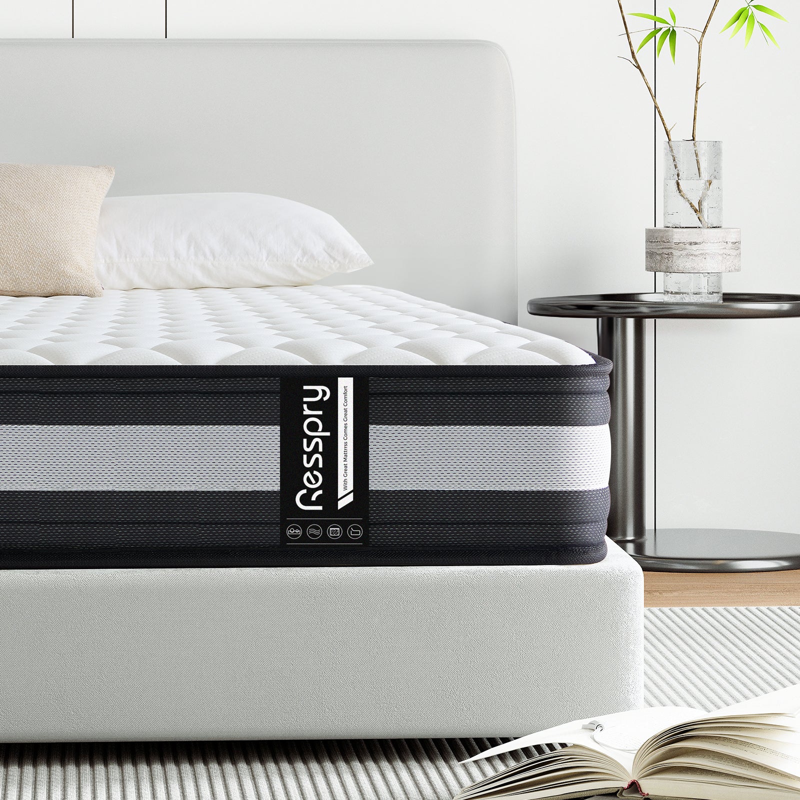 A hybrid mattress by Resspry displayed on a bed frame, featuring a white and gray color scheme with the brand name visible on the mattress.